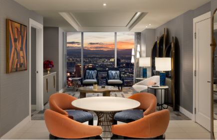 Seating areas with chairs in front of a window with a view of the Strip