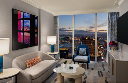 Seating areas with chairs in front of a window with a view of the Strip